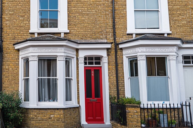In front of a terraced house in the concept of 'top services and amenities in Coulsdon'.