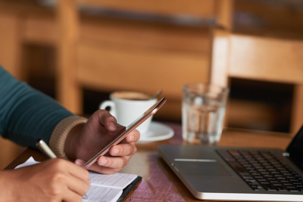 Cropped image of a person booking home removals services online through a mobile phone