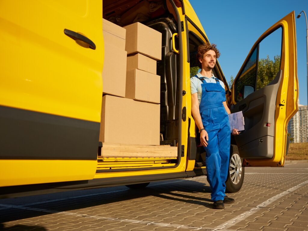 Man and Van Standing Outside the Driver's Seat of the Yellow Van